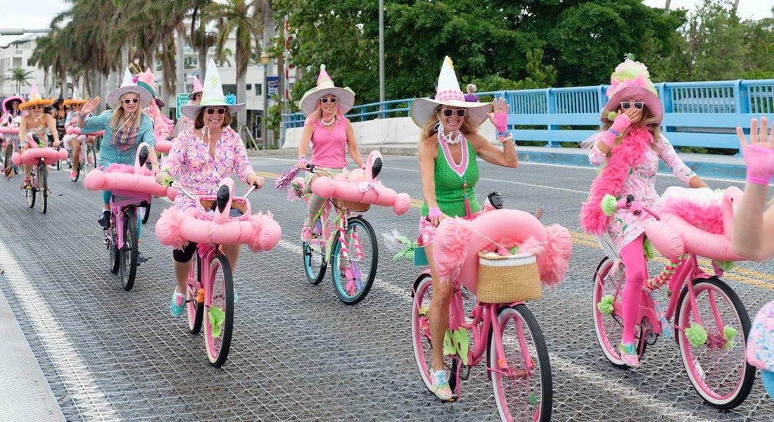 The "Witches of Delray" ride their pink, decorated bicycles over the bridge in Delray Beach.